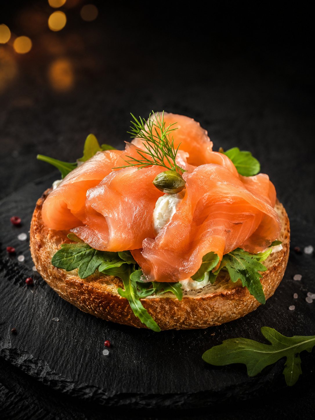 Smoked salmon cicchetto with dill and capers on dark slate